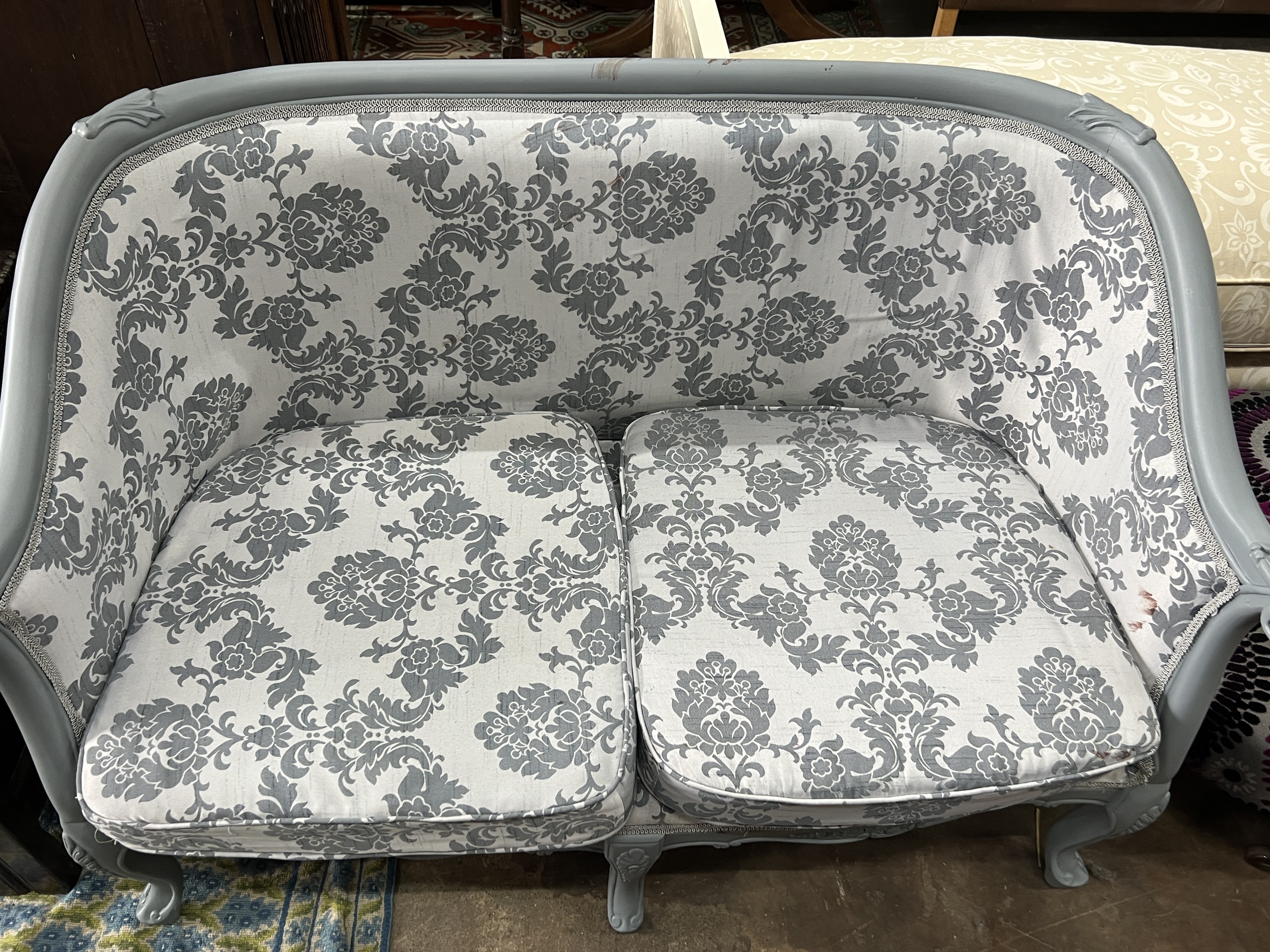 A Louis XVI style upholstered grey painted tub framed two seater settee, length 119cm, depth 60cm, height 82cm